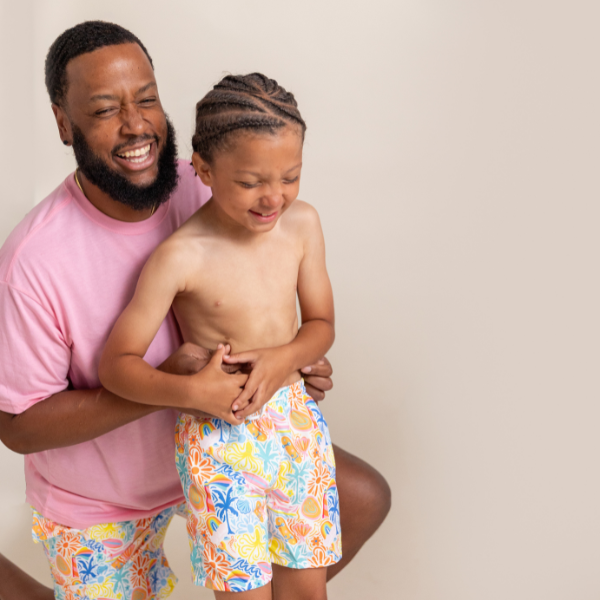 dad and son wearing matching swimsuit trunks
