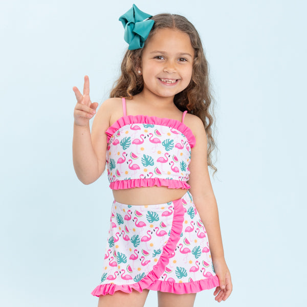 Young girl in flamingo two piece swimsuit
