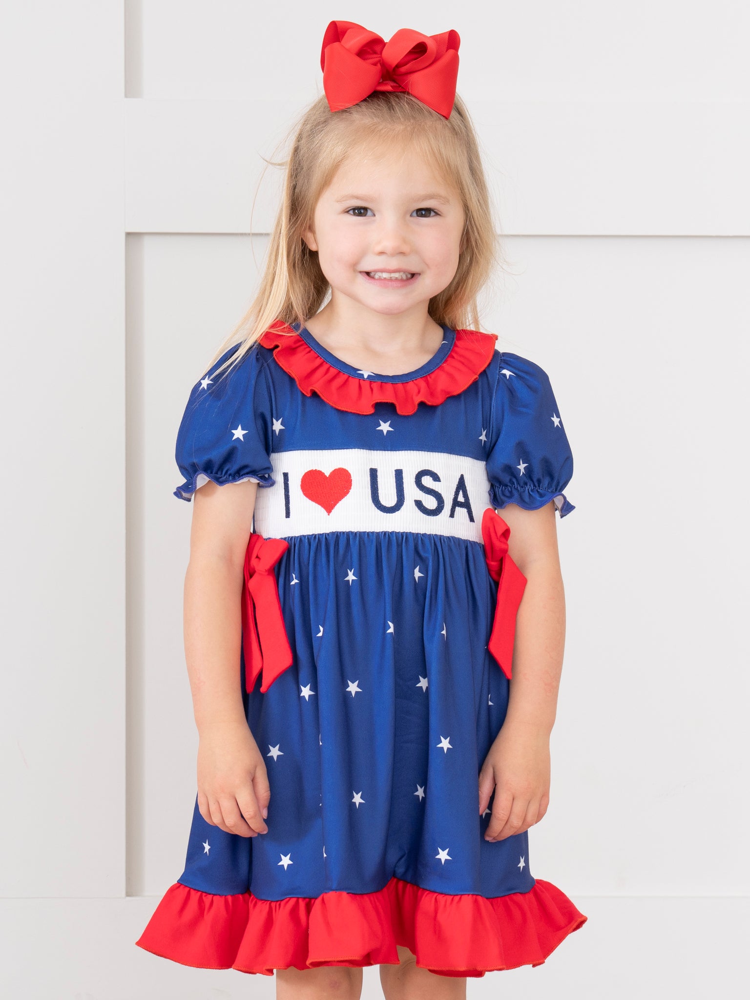 USA Love Smocked Bow Dress - Marie Nicole Clothing XS(18/24mos) USA Love Smocked Bow Dress - Marie Nicole Clothing XS(18/24mos)