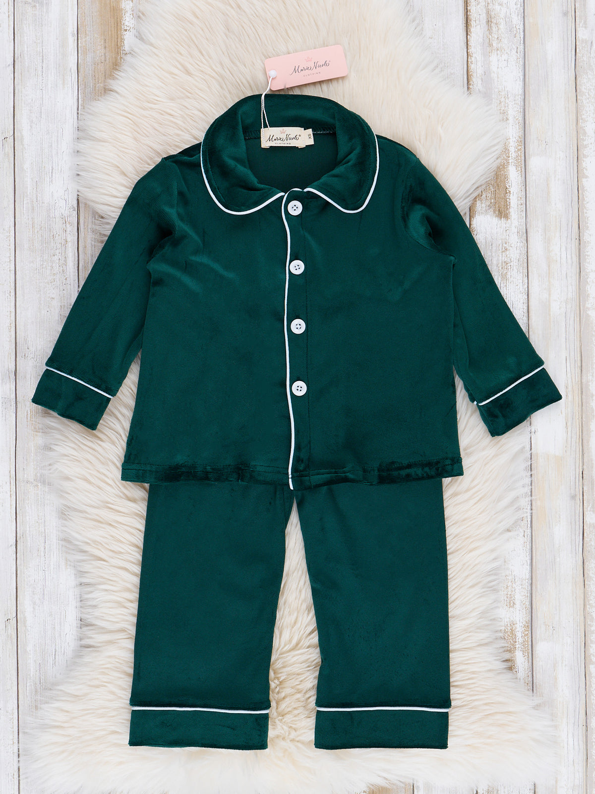 Boys' Green velvet pajama set with white trim on a textured surface with cream rug