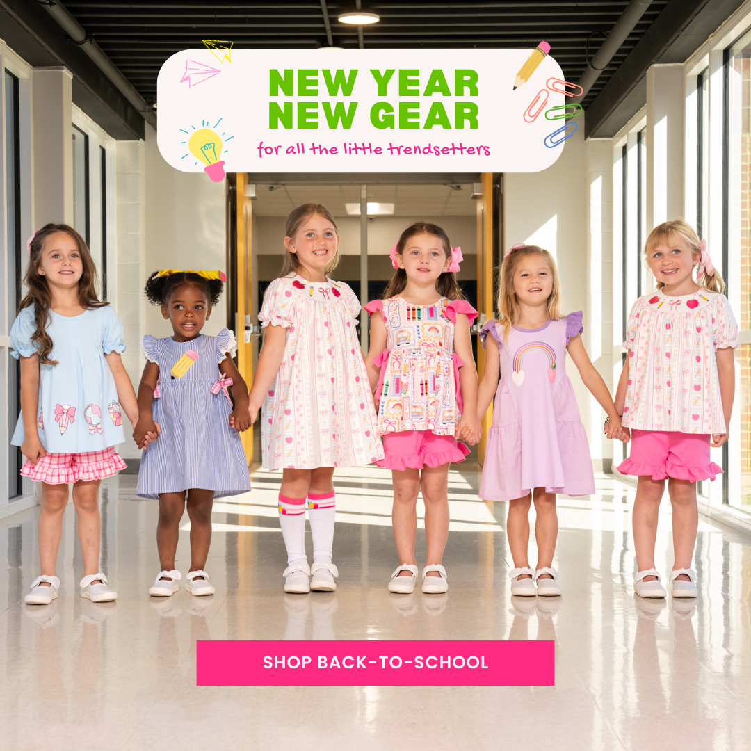 Young girls wearing back to school outfits in school hallway - shop back to school