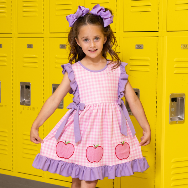 young girl wears apple gingham dress