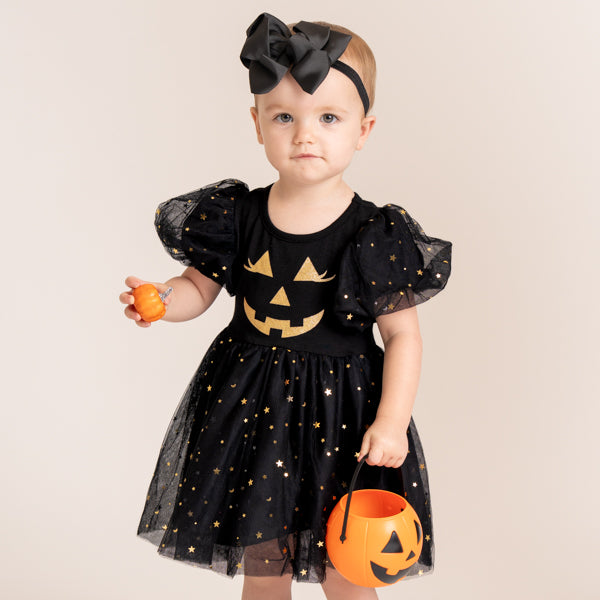 baby wears black Halloween dress