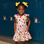 young girl wears pencil and apple dress