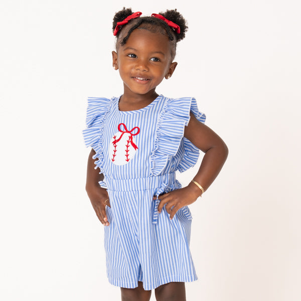 young girl wearing baseball romper with white background