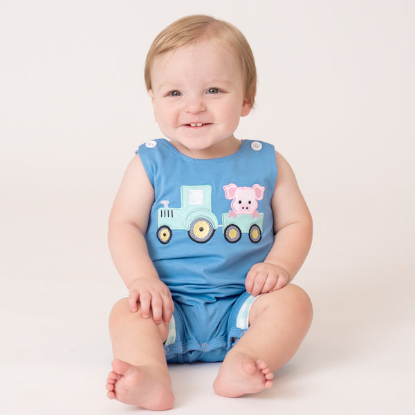 baby boy in farm romper