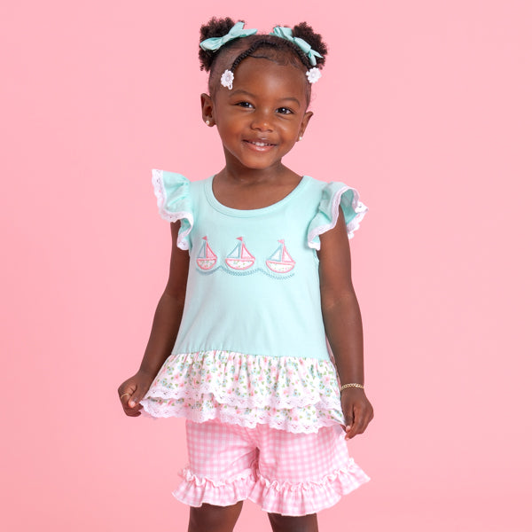 young girl wearing sailboat outfit