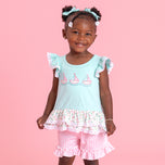 young girl wearing sailboat outfit