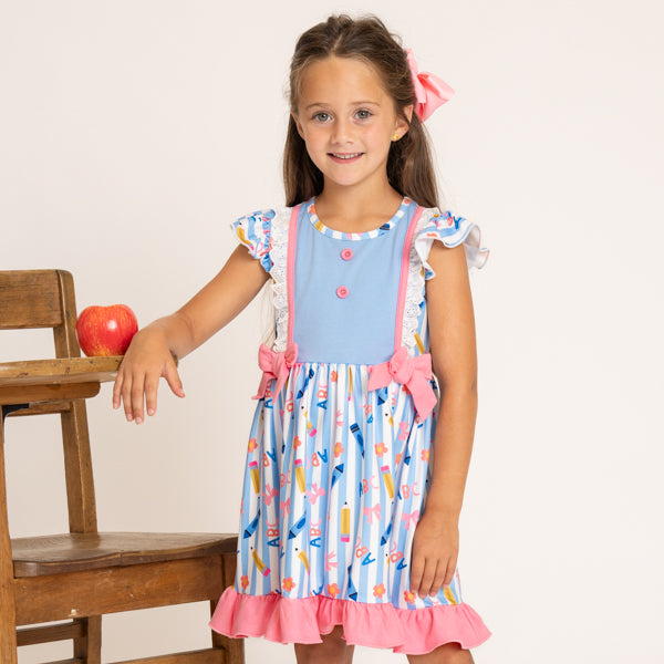 young girl wearing back to school dress