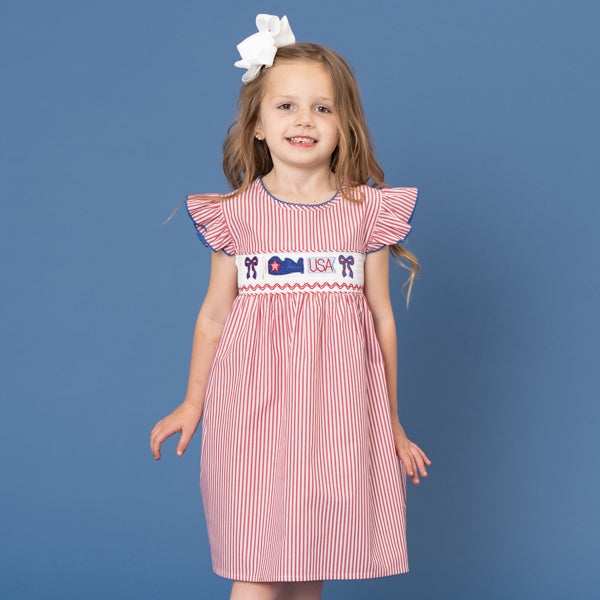 young girl wears red striped USA dress