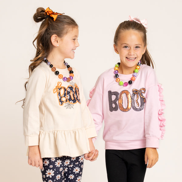 two girls wear Halloween outfits