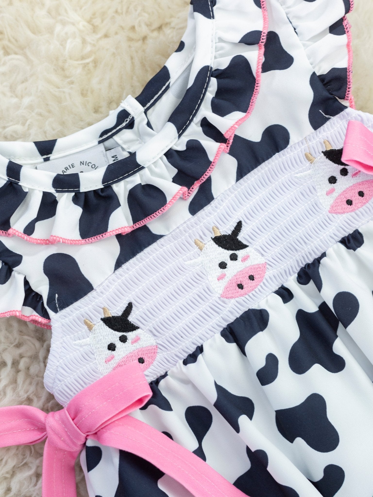 Smocked Cow Print Bow Ruffle Romper - Marie Nicole Clothing